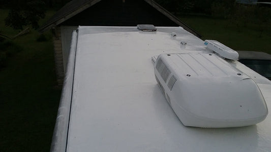 RV roof fully coated with RV Roof Magic white liquid rubber sealant for waterproofing and long-term protection.